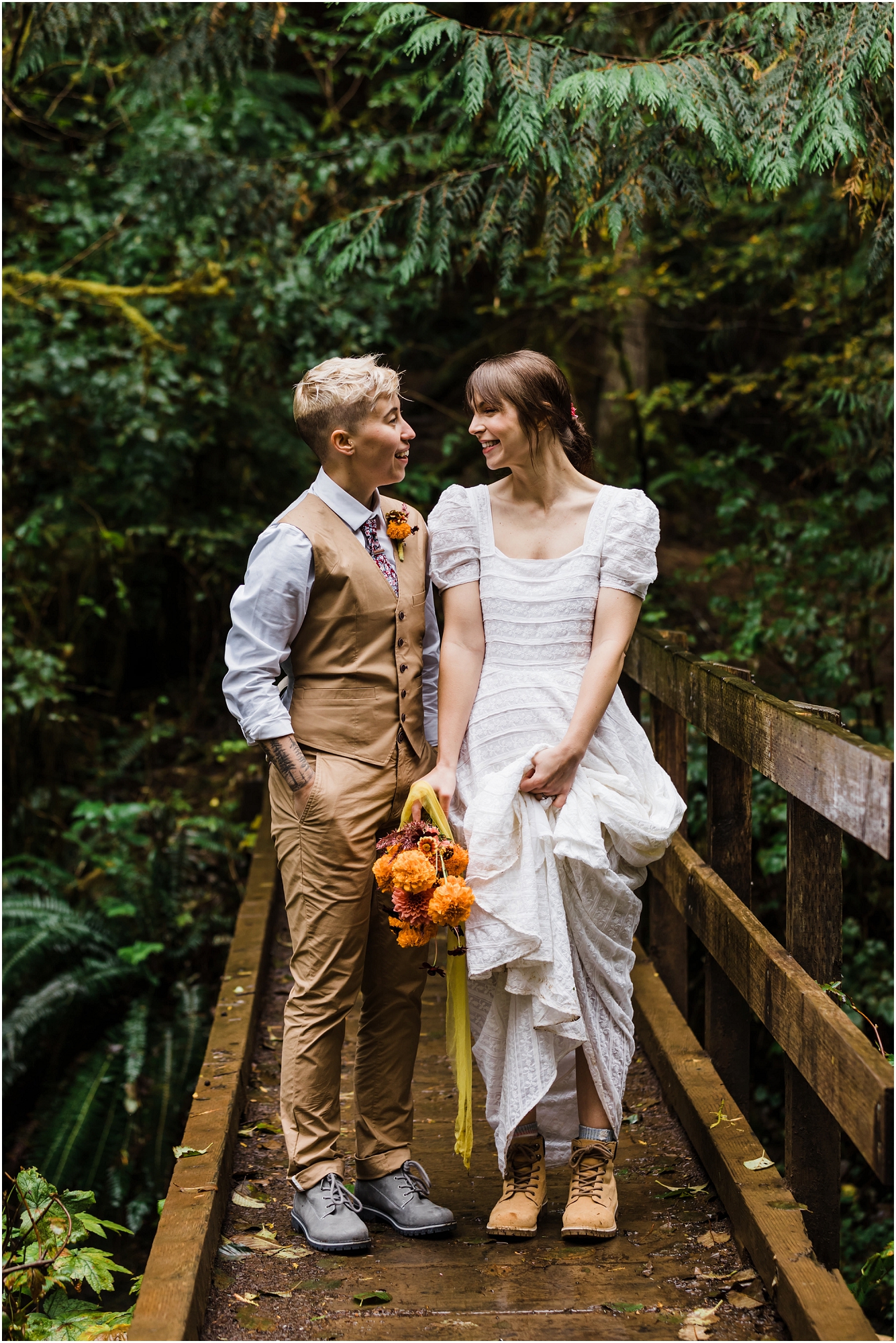 A wooden bridge crossing a creek with a puddle creates the perfect reflection of this couple in their wedding clothes for their Oregon adventure elopement. | Erica Swantek Photography
