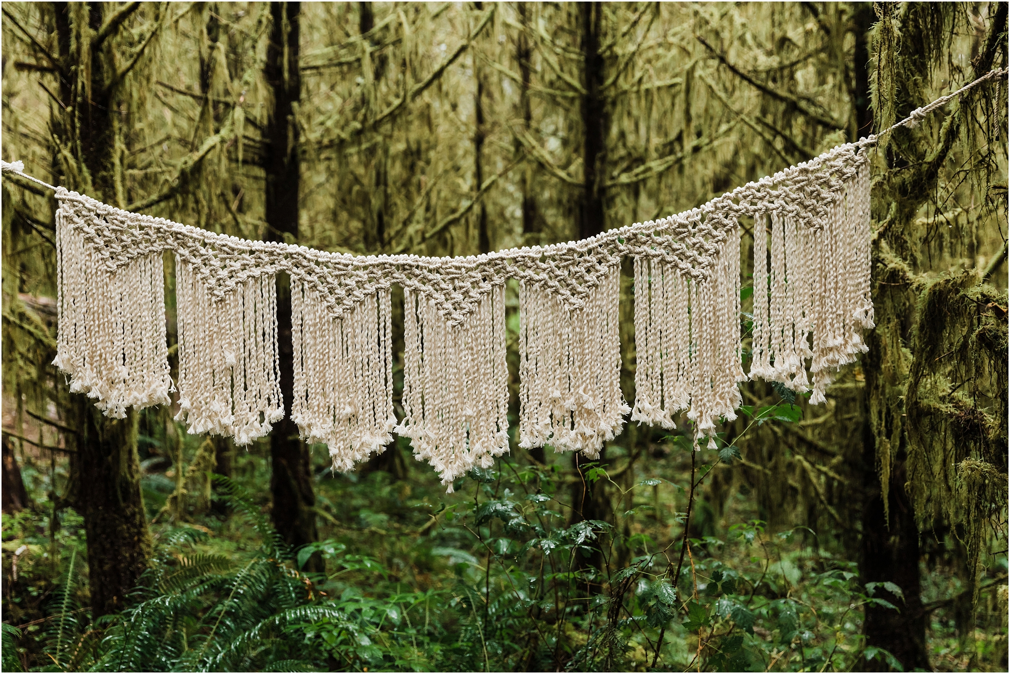 A beautiful macrame wedding ceremony backdrop created by the Slow Cult out of Portland, Oregon for a PNW hiking adventure elopement on the coast. | Erica Swantek Photography