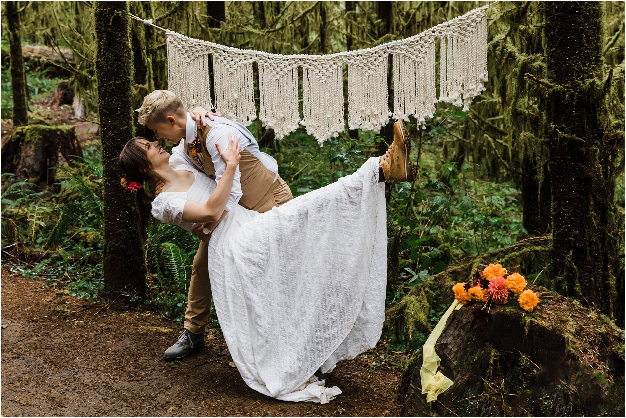 A bride gets a dip from her partner at her PNW hiking adventure elopement along the Drift Creek Falls trail in Oregon. | Erica Swantek Photography
