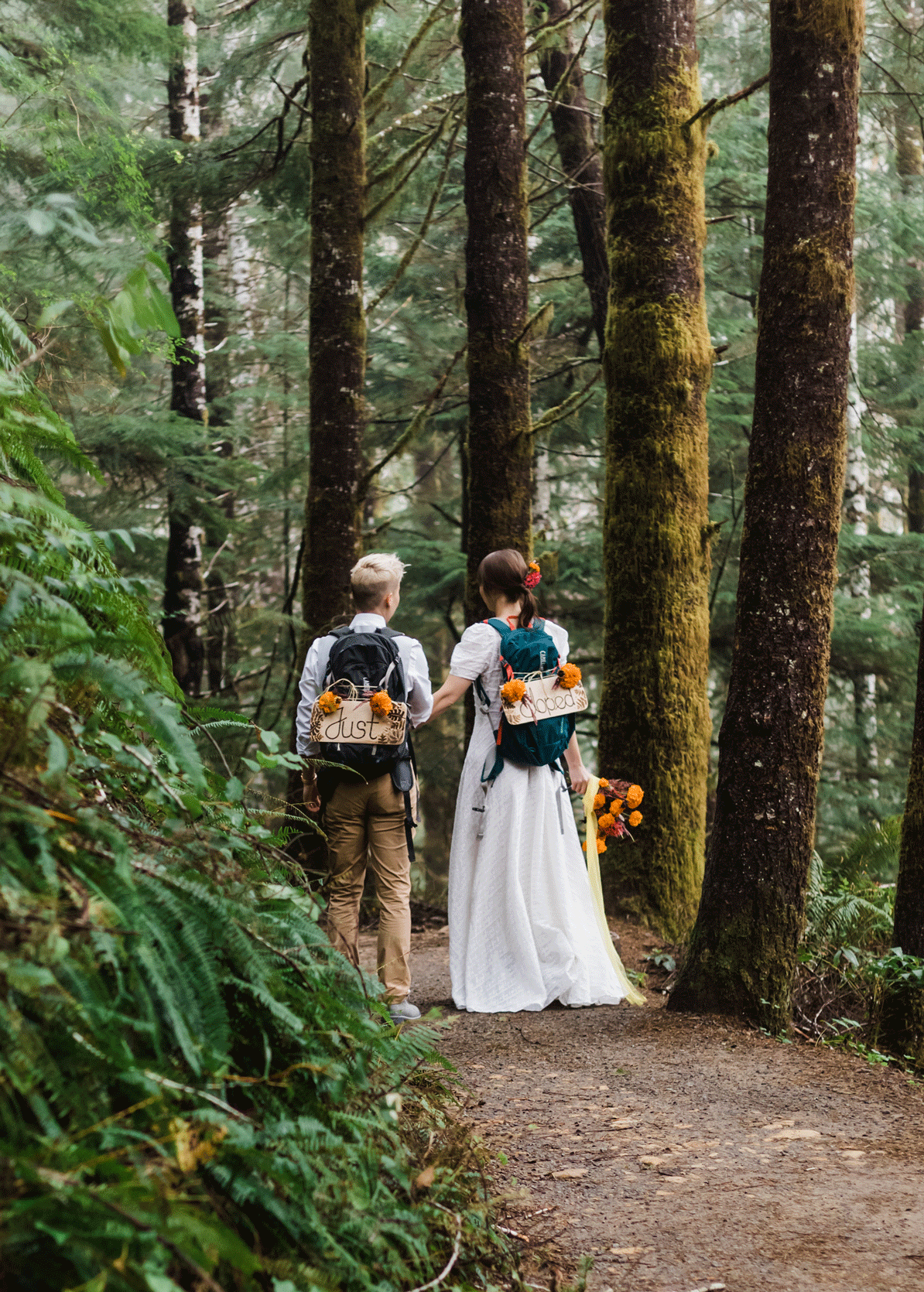 A couple dances in their wedding attire on the trail to an Oregon waterfall for their PNW hiking adventure elopement. | Erica Swantek Photography
