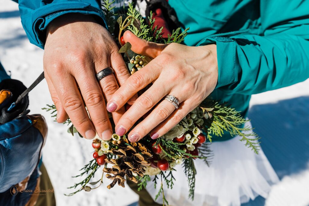 close up of bride and groom showing off wedding rings