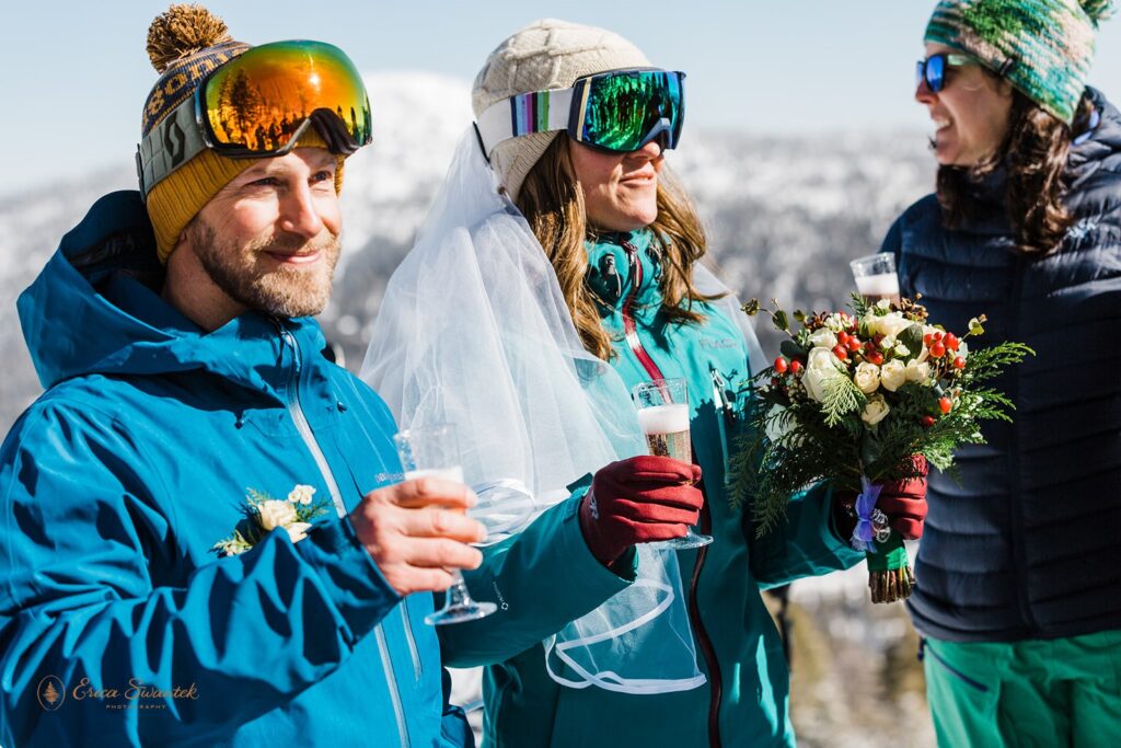 elopement couple toasting champagne on the mountain with their friends
