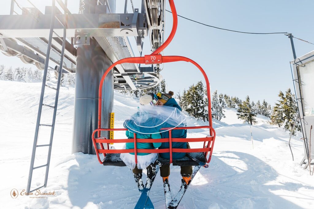 bride and groom on a ski lift at mt bachelor