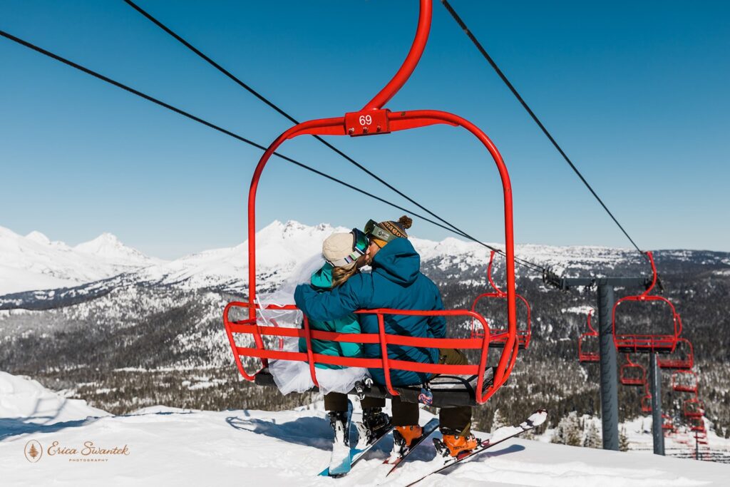 bride and groom kissing on a ski lift