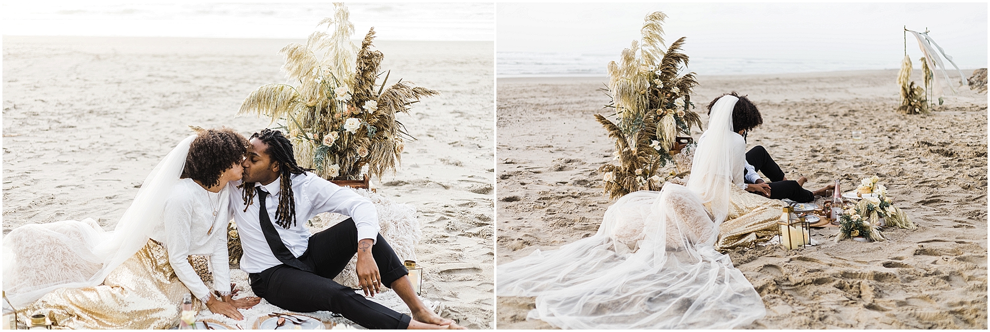 A black couple sits barefoot on the beach in the sand enjoying a romantic picnic with a charcuterie board, cake and champagne. A lovely sitting area with cream pillows, a white rug and beautiful florals decorate the sand for an intimate Oregon Coast elopement at Proposal Rock. | Erica Swantek Photography
