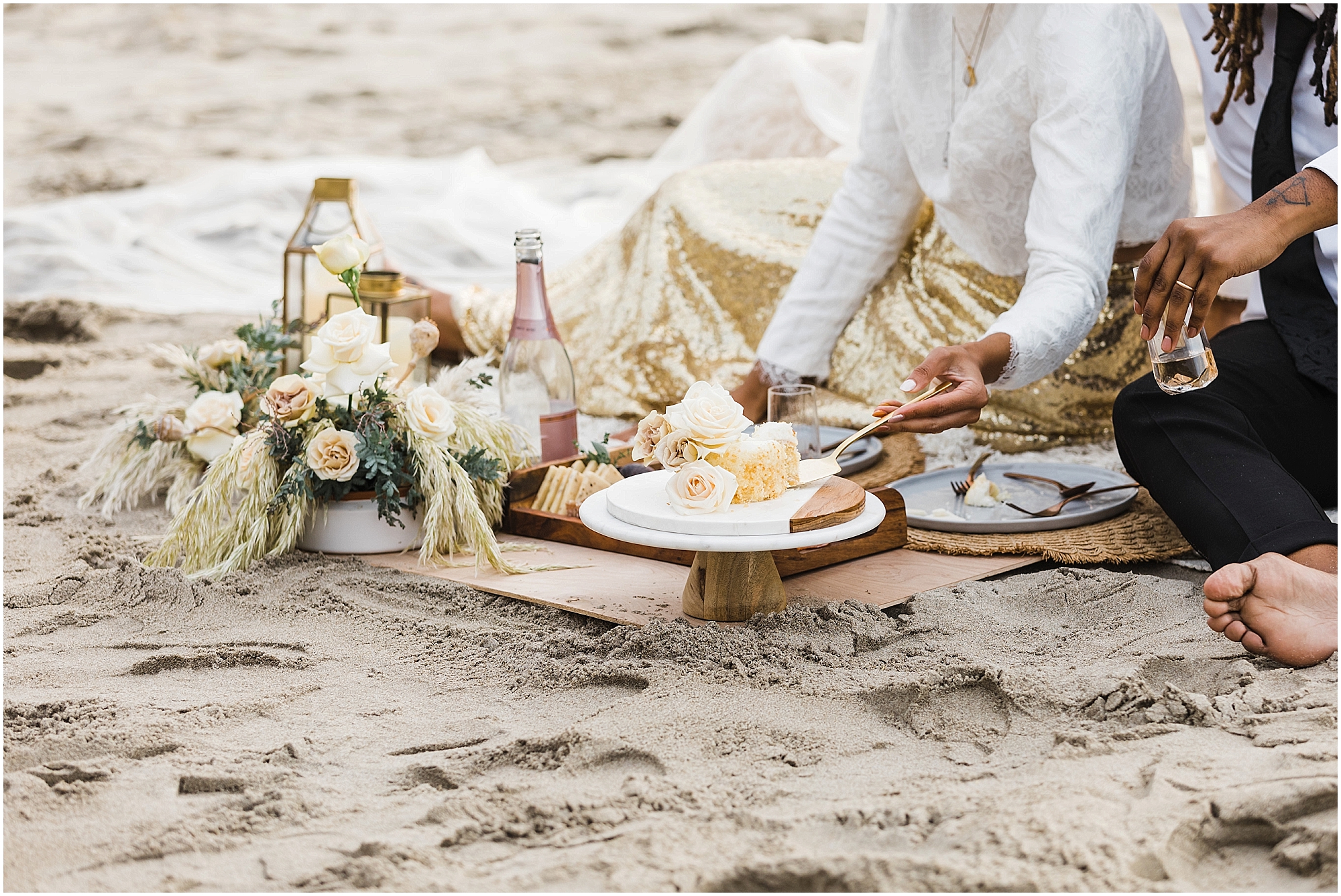 A couple cuts their wedding cake during their picnic on the beach after their intimate Oregon Coast elopement ceremony near Lincoln City. | Erica Swantek Photography