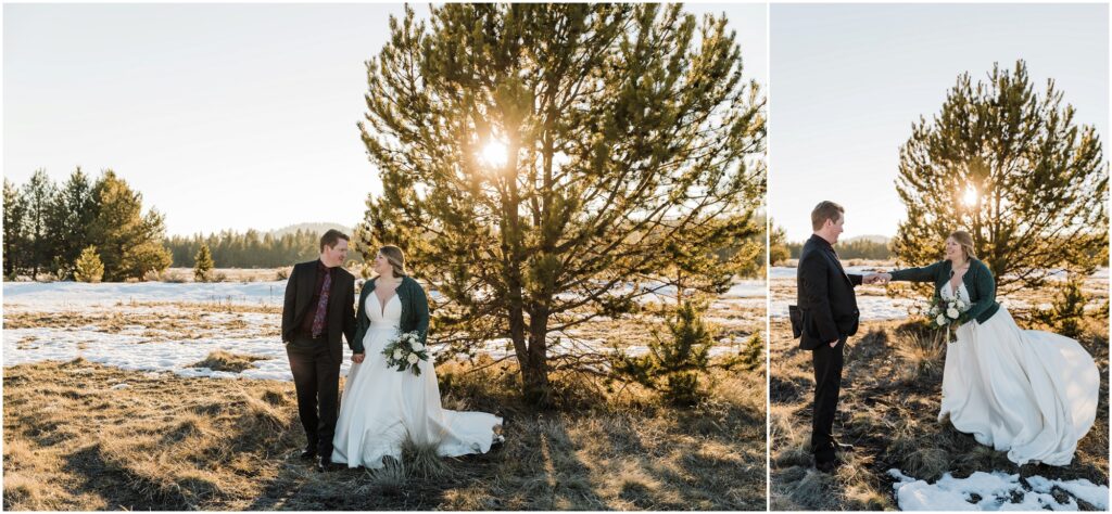 A bride in a cream colored gown with a green sweater holds a bouquet of white and green flowers while walking with her groom in a black suit and burgundy tie through the snow in Sunriver in this where to elope in Bend guide. 