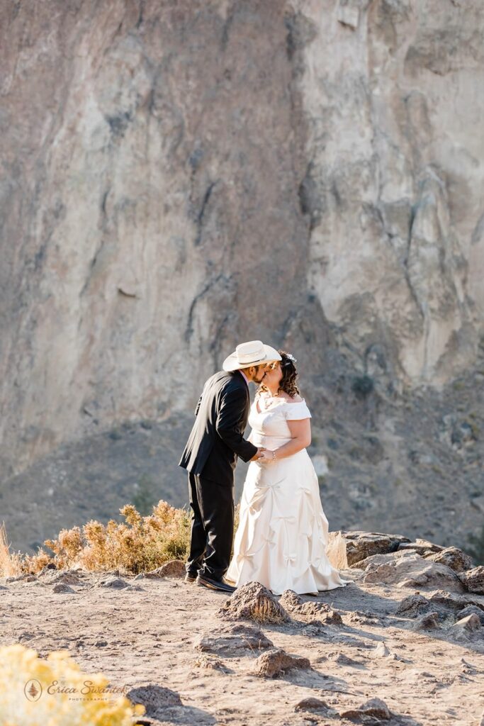 A couple kisses at Smith Rock State Park in Oregon during their ceremony.