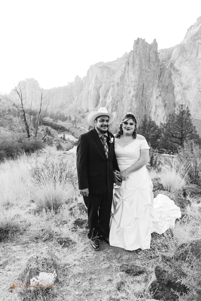 A couple stands for portraits at Smith Rock State Park.