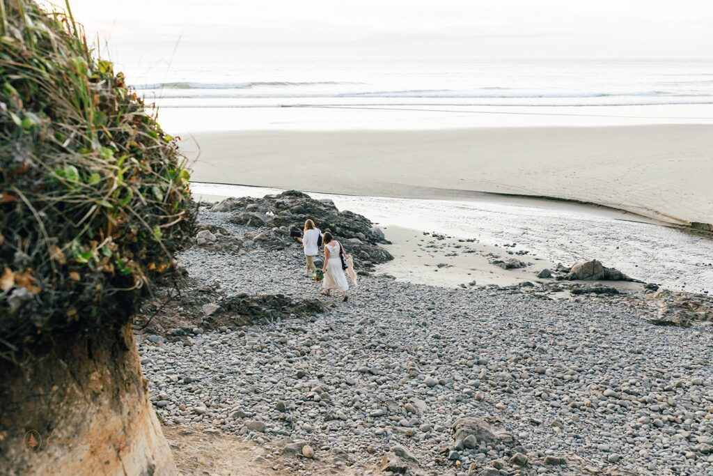 A couple walks along an Oregon coast beach.