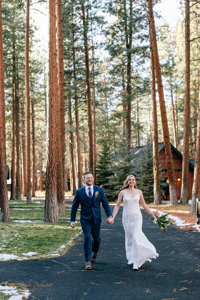 A couple holds hands during their elopement at a lodge in Oregon.