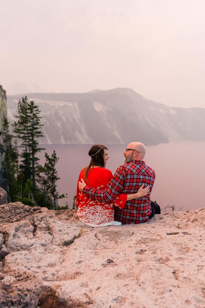 Couple laughs with one another while admiring Crater Lake.
