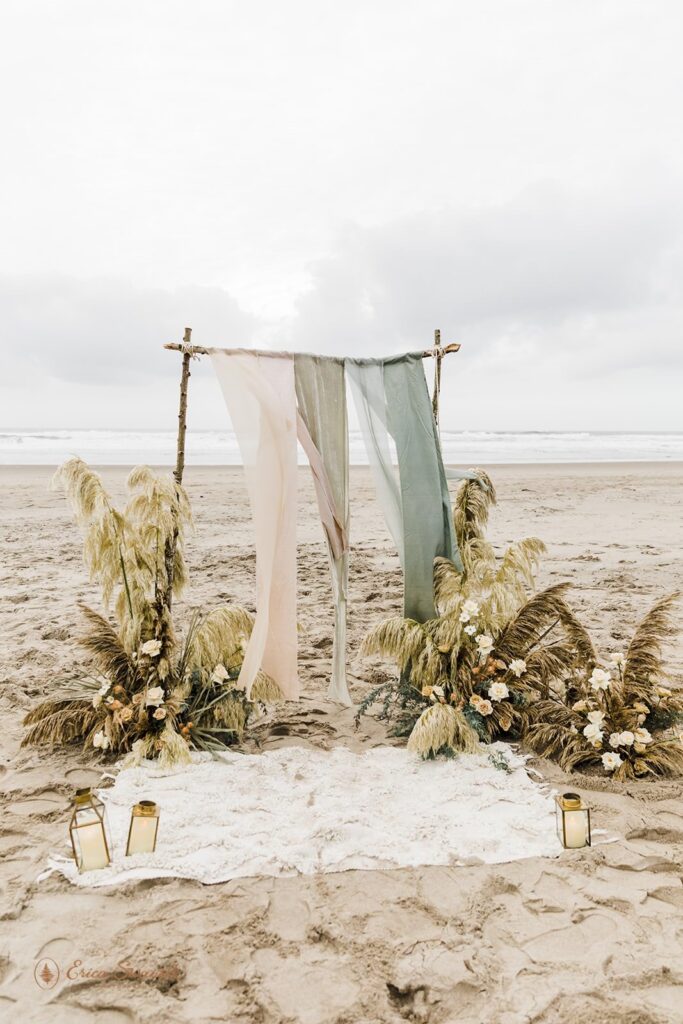 A beach ceremony in Oregon with a arch.