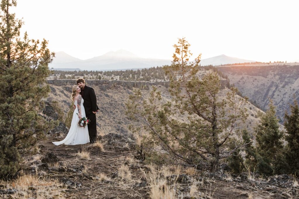 A couple smiles for a wedding portrait in the desert of Central Oregon.