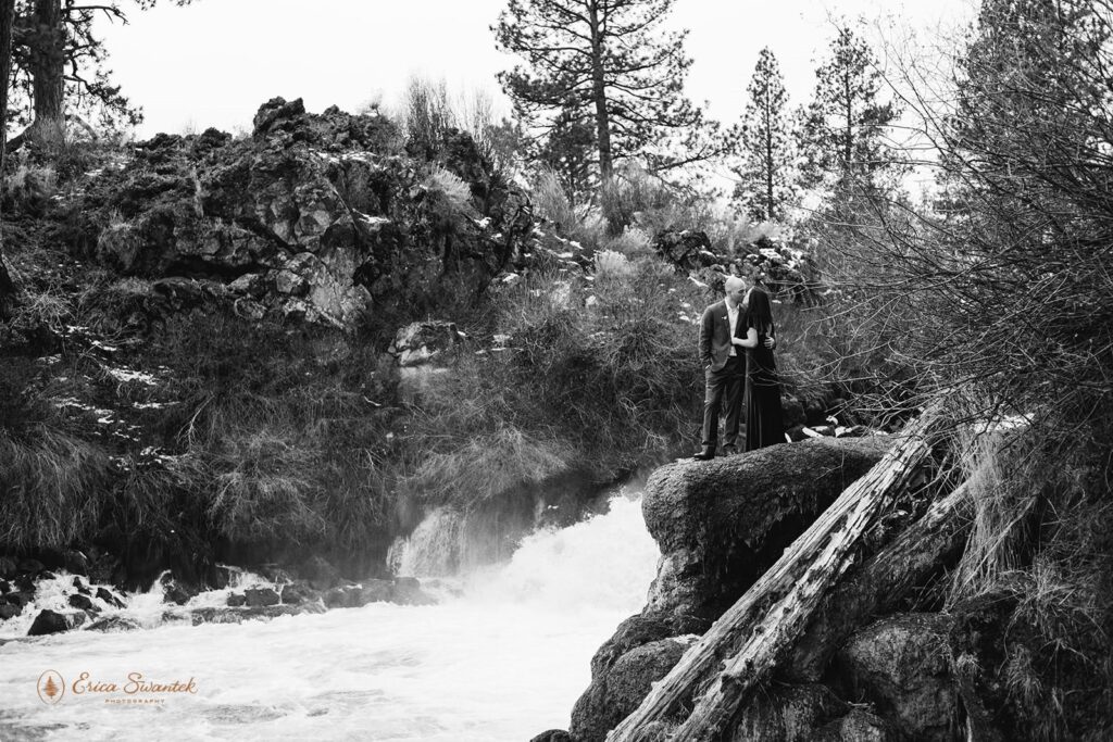 A couple stands near a River in Oregon during their elopement.