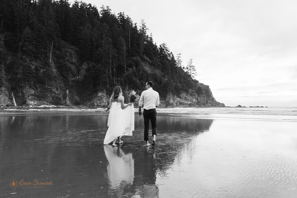A couple walks along a beautiful Oregon beach for their intimate wedding celebration.