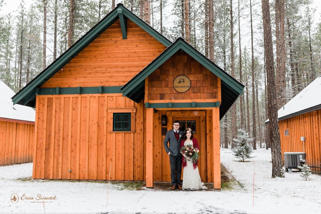 A couple poses for wedding portraits at a lodge in Oregon.