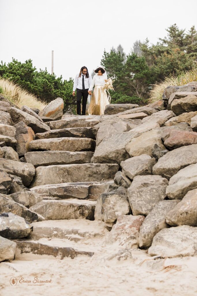 A couple walks down steps to an Oregon beach for their wedding.