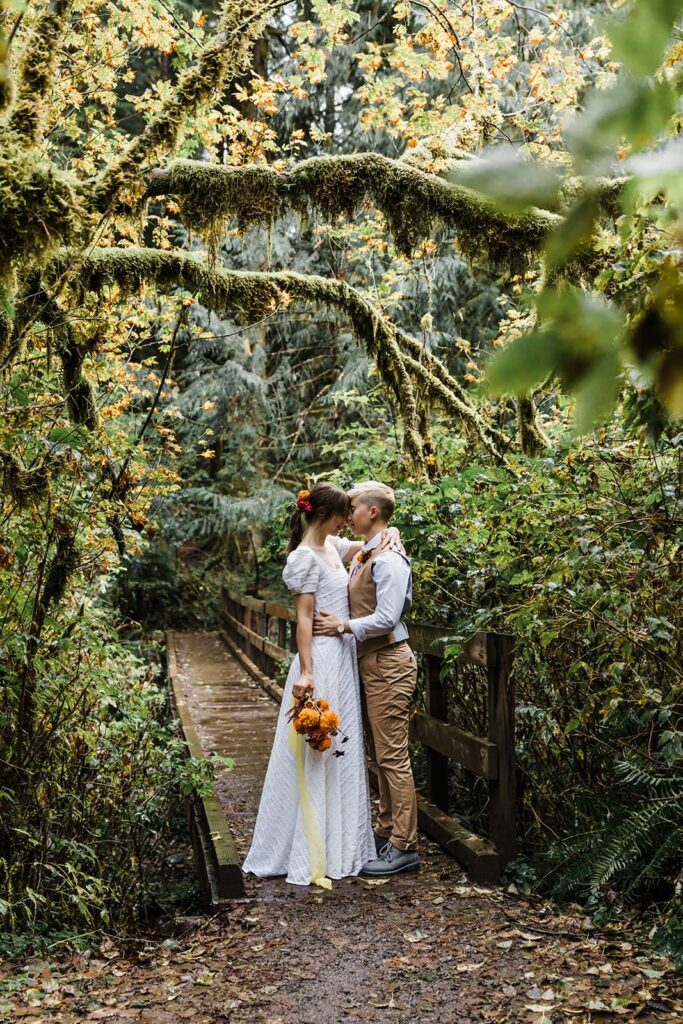 A couple embraces in a forest in Oregon.