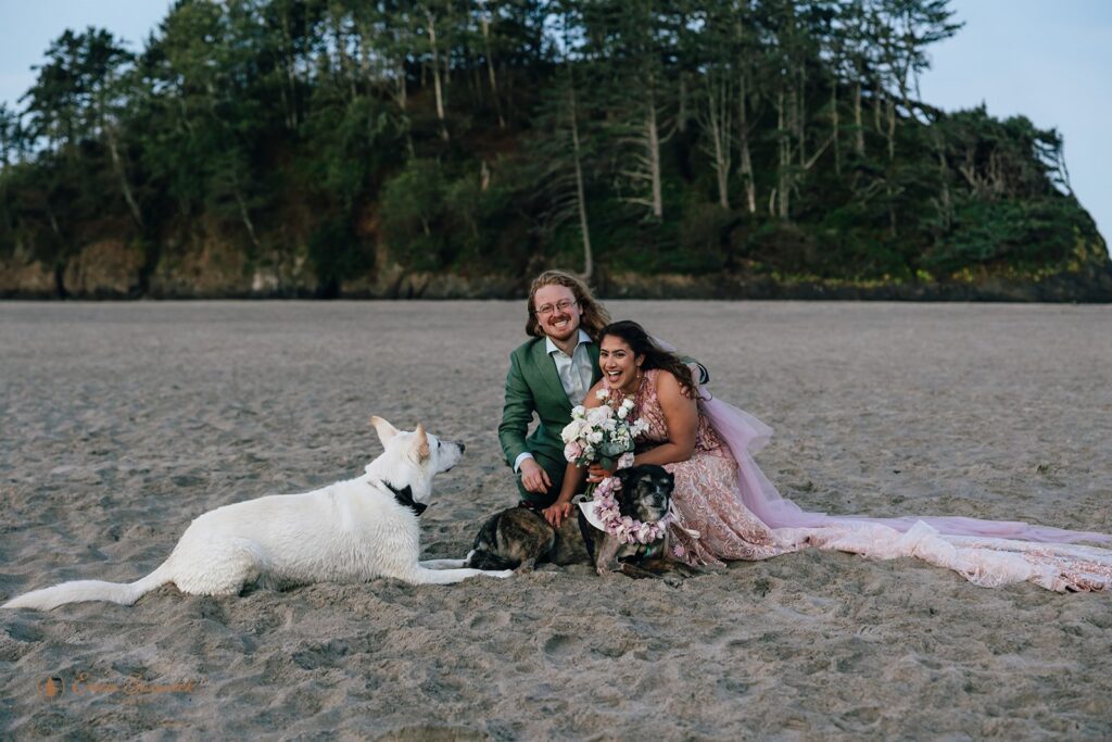 elopement couple snuggling their dogs during their oregon coast elopement day