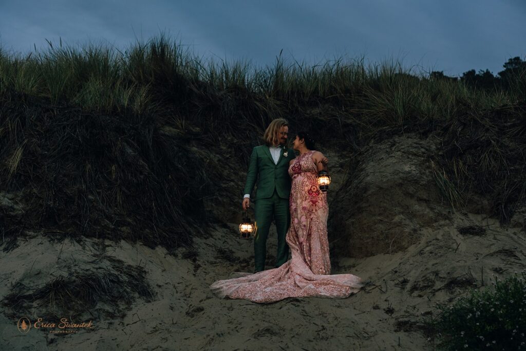 elopement couple posing at sandy dunes with lanterns