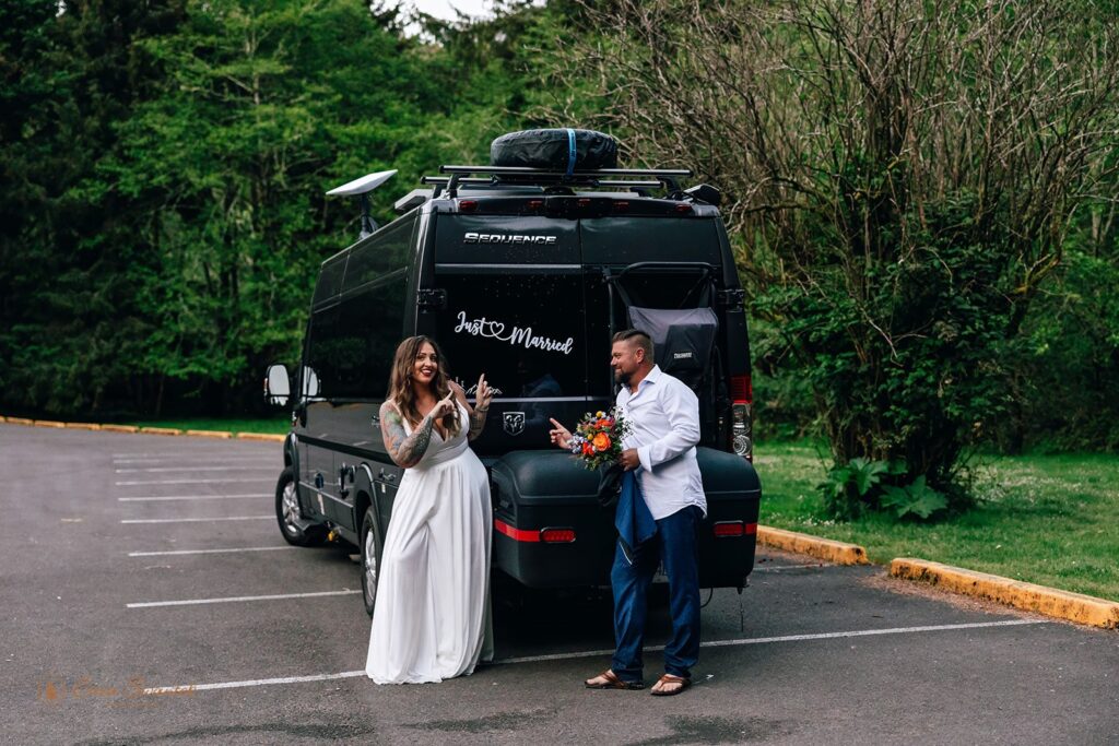 oregon elopement couple posing by their 'just married' van sign
