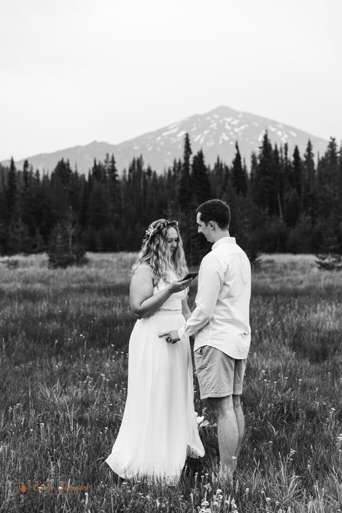 A couple recites vows in a quiet Oregon meadow.