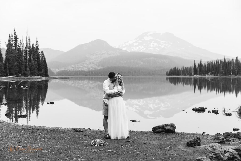 A couple holds one another while on a hiking elopement in Oregon.