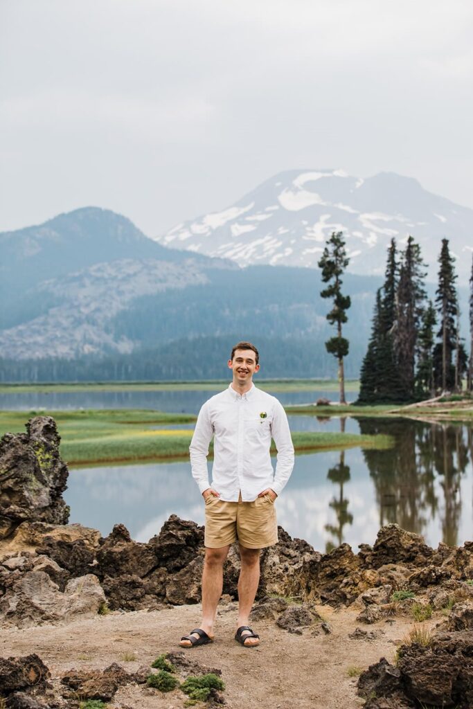 A man stands in front of Sparks Lake.