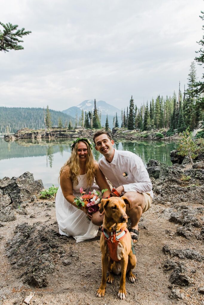 A couple hangs out with their dog during their lake elopement.
