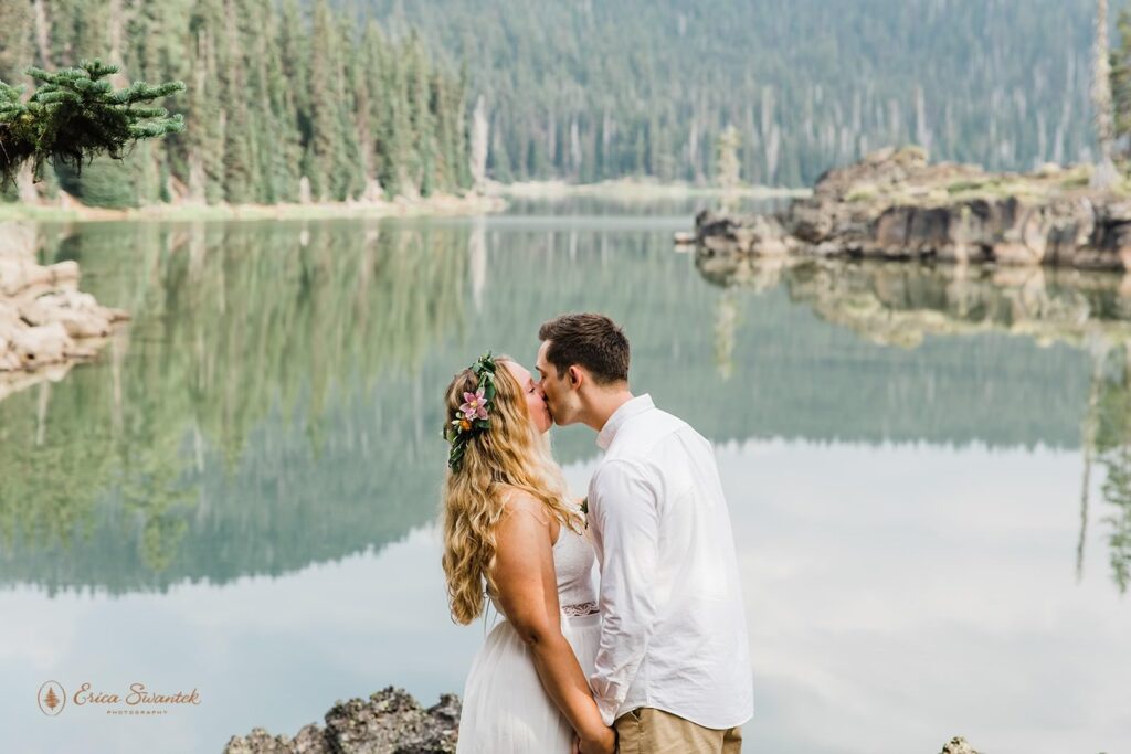 A couple kisses after saying I Do at Sparks Lake.
