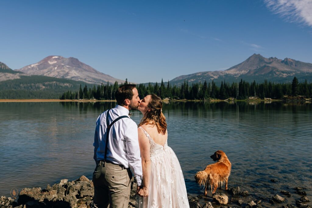 elopement couple sharing a kiss near Sparks lake with stunning mountain views