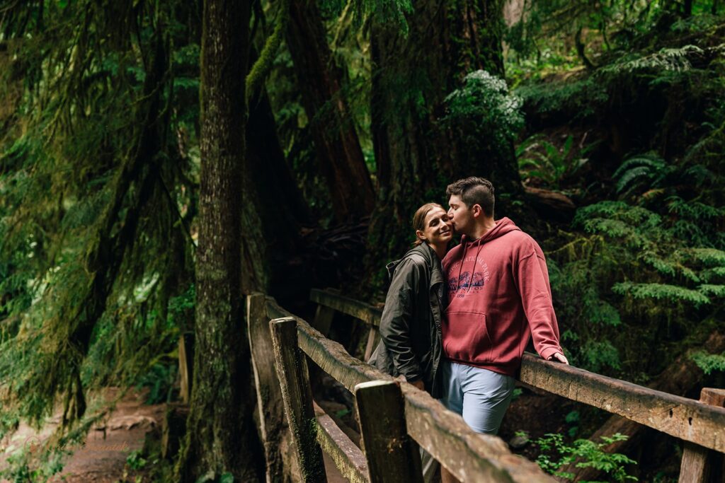 bride and groom hiking through a lush forest during their elopement in washington state