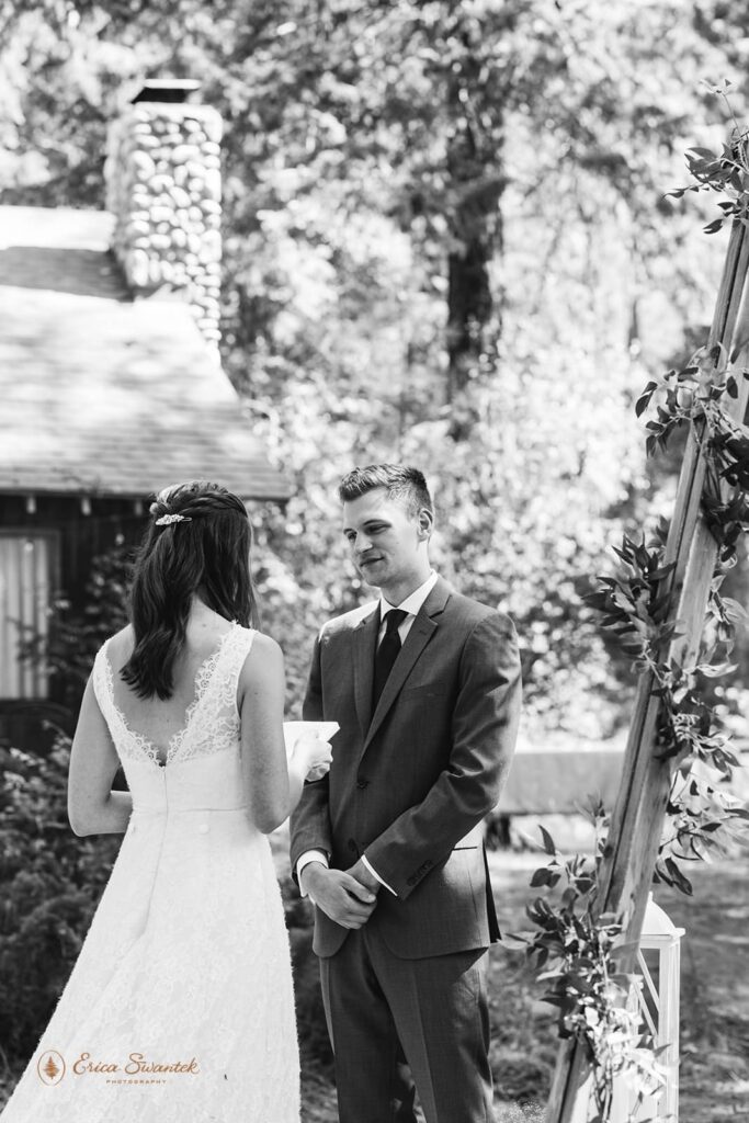 A couple exchanges vows during their forest elopement.