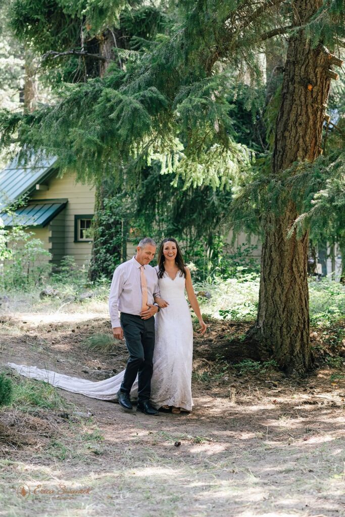 A father walk's a bride down the aisle for a cabin elopement in Washington.