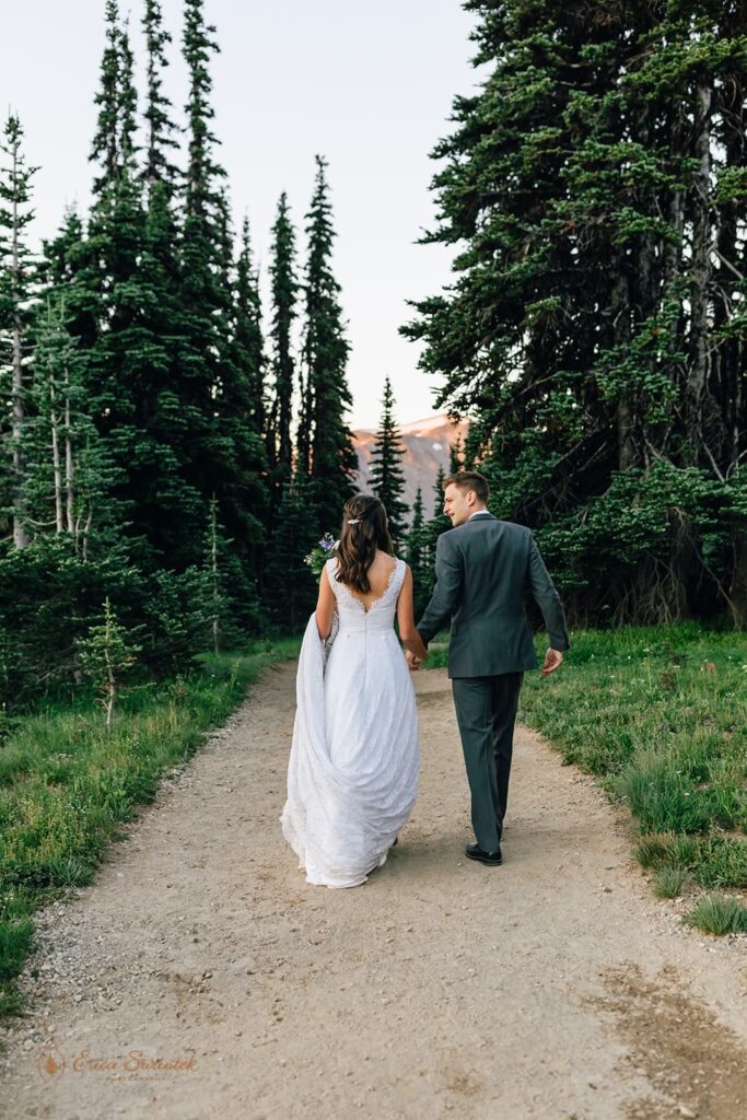 A couple is hiking on a trail for their  Mt. Rainier elopement.