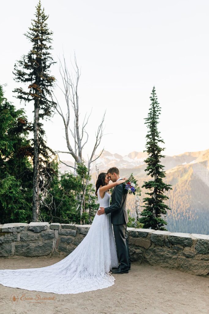 A couple embraces near an overlook at Mt. Rainier National Park.