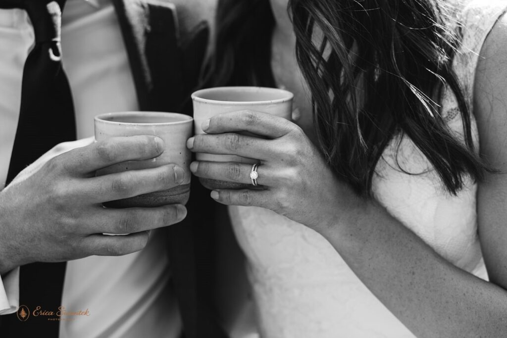 A couple cheers cups of coffee before their elopement ceremony at Whistlin' Jack's.