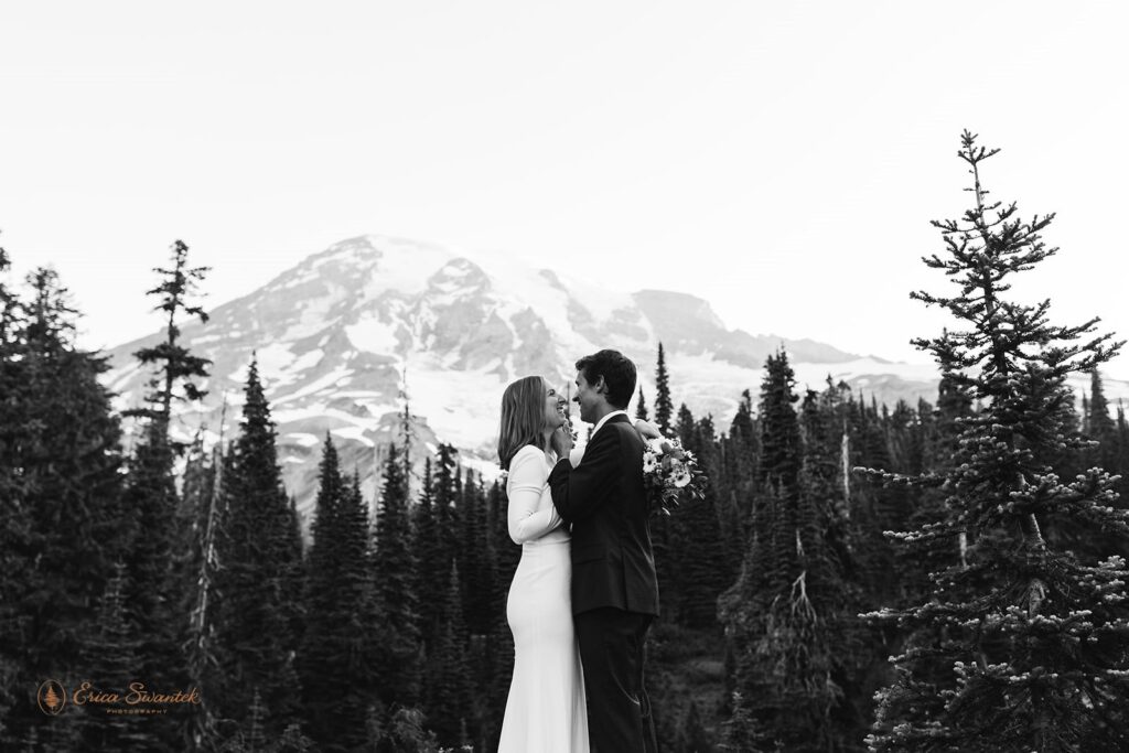 A newlywed couple goes in for a kiss during their mountain elopement in Mt. Rainier National Park. 