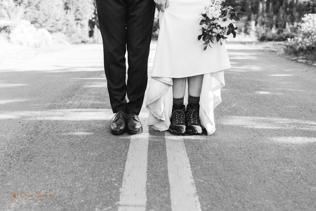 A couple shows off their hiking boots during a mountain elopement in Washington State.