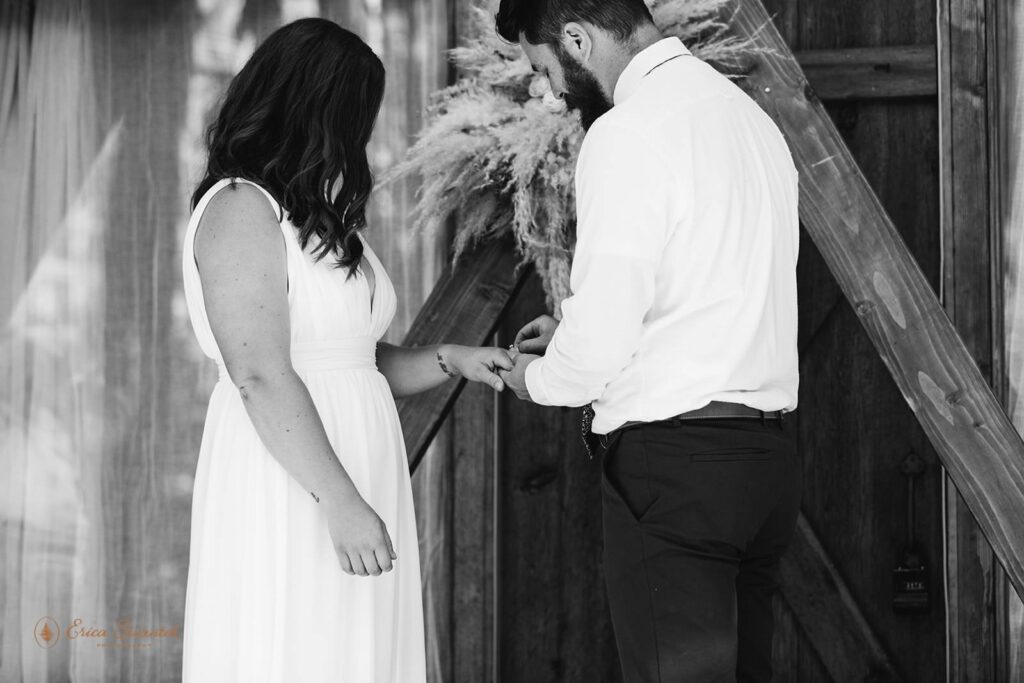 A bride and groom exchange rings during a Washington State vow ceremony at a cabin.