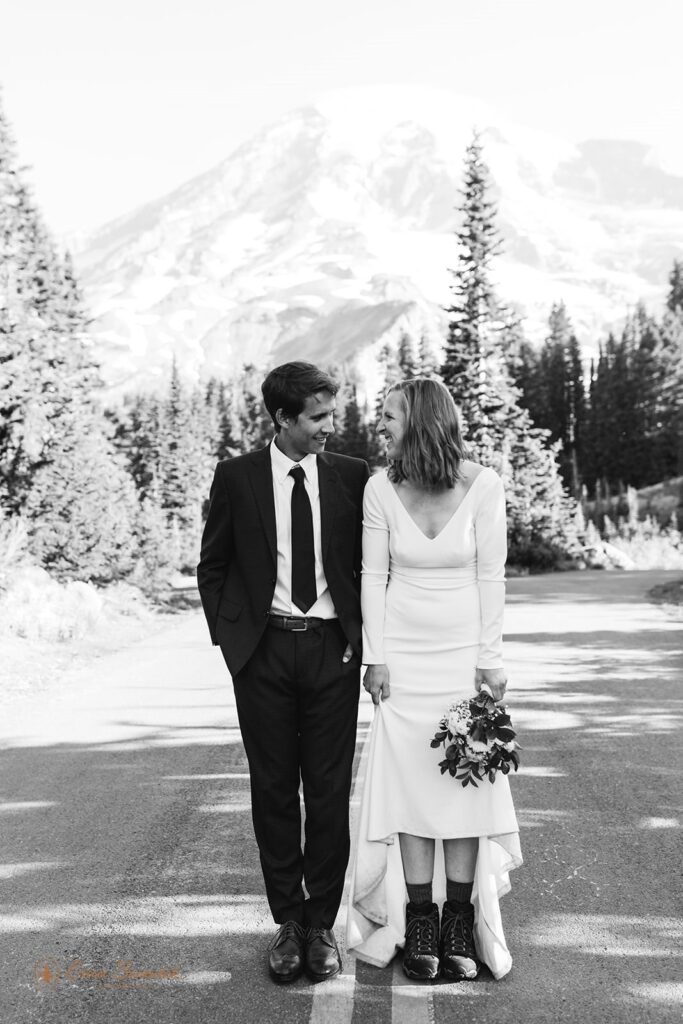 A newlywed couple shows off their hiking boots during their Washington elopement at Mt. Rainier. 