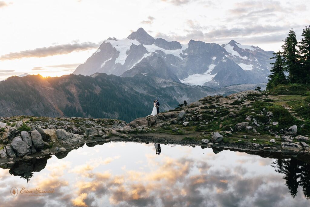 A small alpine lake reflects a Sunrise in Washington State.