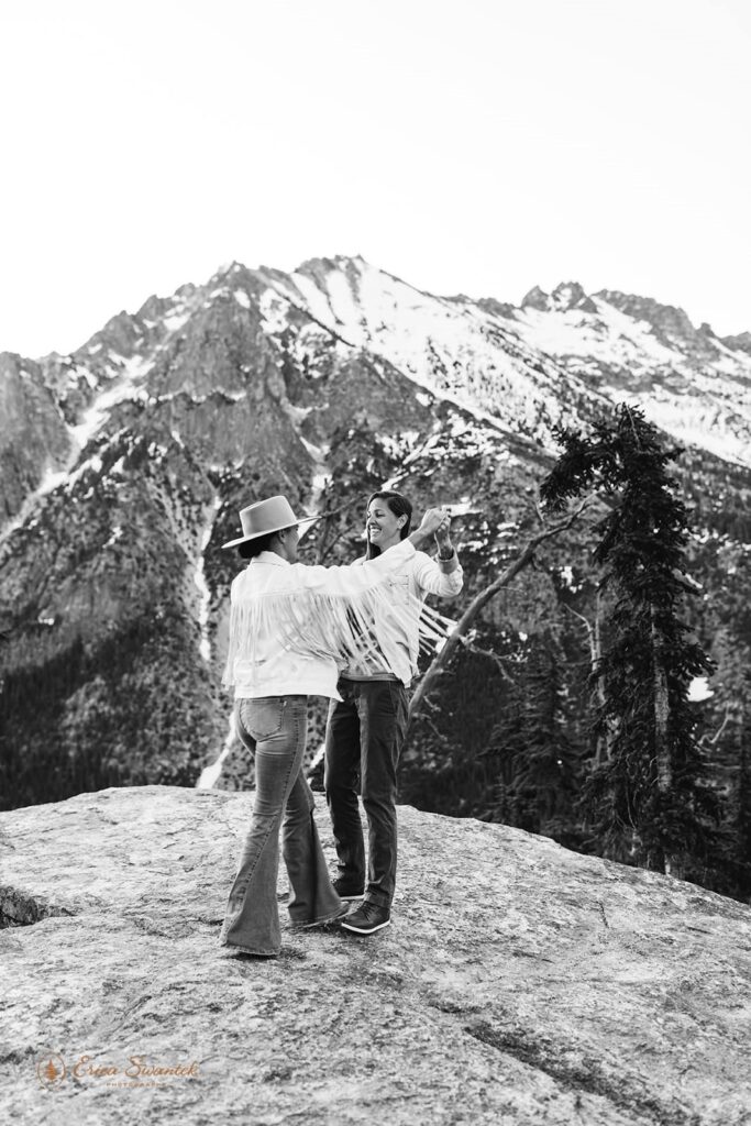 A couple dances on a rocky overlook in the mountains of Washington State.