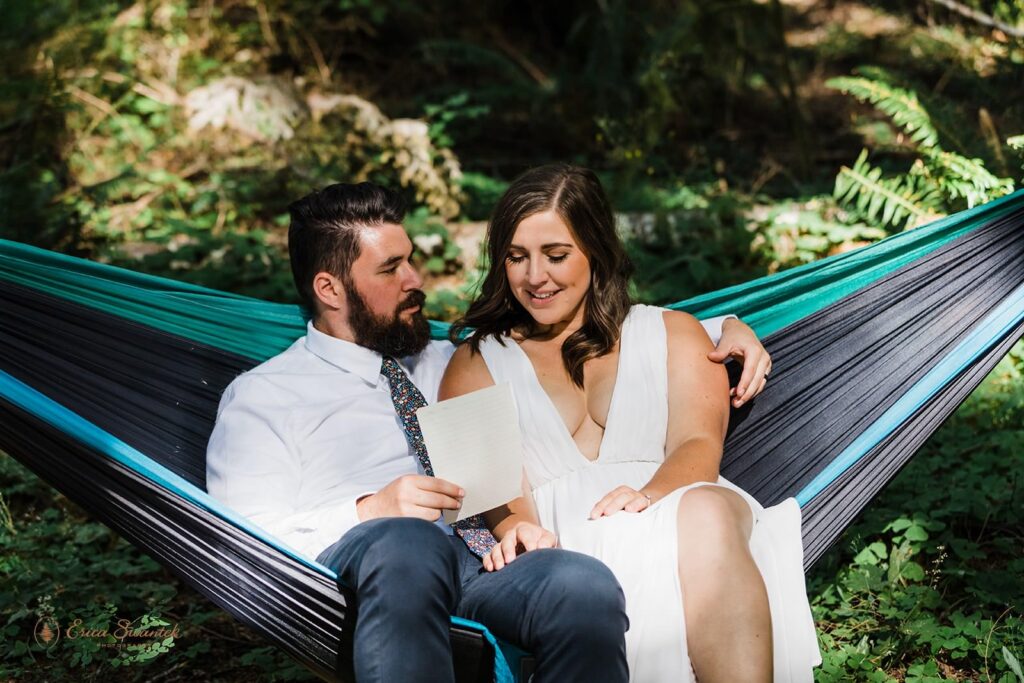 A couple sits in a hammock while sharing private vows. 