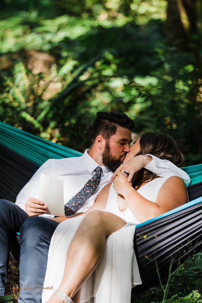 A couple kisses in a hammock during their Washington State elopement.