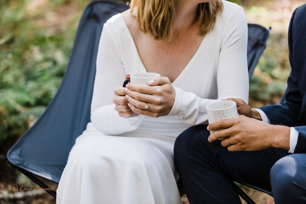 A couple shares drinks during their camping elopement in Washington. 