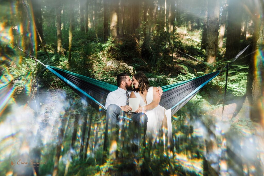 bride and groom sitting in a hammock together
