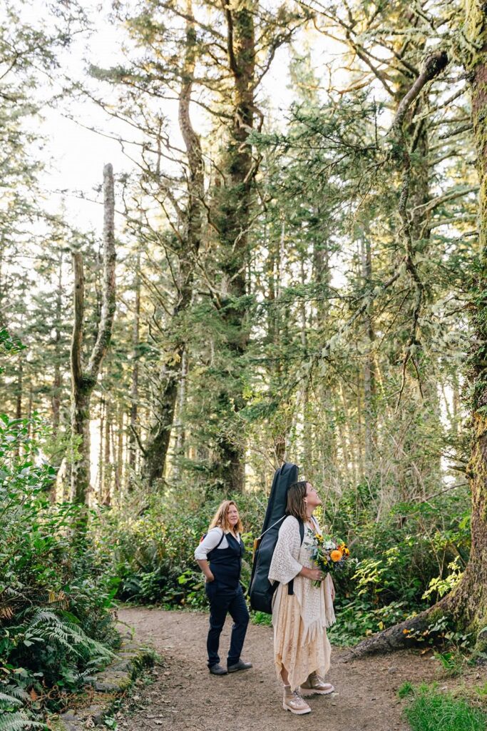 A couple wanders through a Sitka spruce forest searching for a vow ceremony spot.