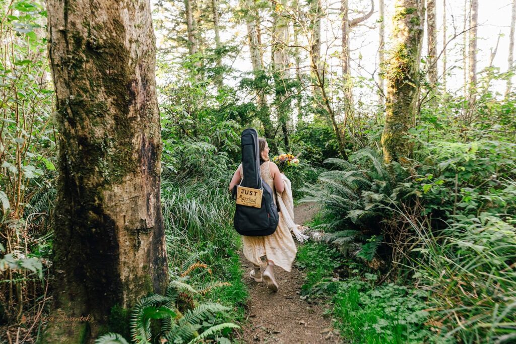 A couple hikes through Siuslaw National Forest near the Oregon Coast during their forest elopement.